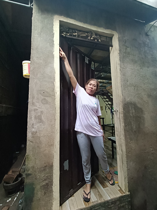 Resident of an informal settlement is showing the level of the last flood some days ago in Bacalod Resident of an informal settlement is showing the level of the last flood some days ago in Bacalod