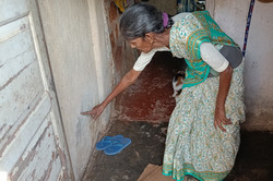 Resident showing the level of floodwater overflowing into the house during the monsoon season Resident showing the level of floodwater overflowing into the house during the monsoon season